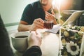 Office coffee break with two designer colleagues sitting chatting over cups of coffee,flower vase,digital tablet docking smart Royalty Free Stock Photo