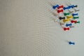Office colorful thumbtacks pushpins on a pining white tan wall Royalty Free Stock Photo