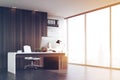 Office of company head with dark wood walls, toned