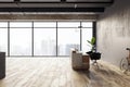 Office corner with city view, wooden desk, and modern design. Industrial ambiance. Royalty Free Stock Photo