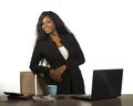 Office corporate company portrait of young happy and attractive black African American businesswoman standing at her computer desk Royalty Free Stock Photo