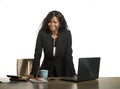 Office corporate company portrait of young happy and attractive black African American businesswoman standing at her computer desk Royalty Free Stock Photo