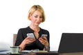 Office corporate portrait of young beautiful and happy business woman sitting at laptop computer desk busy with mobile phones conf Royalty Free Stock Photo