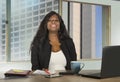 Office corporate portrait of young happy and attractive black African American businesswoman working confident at computer desk sm Royalty Free Stock Photo