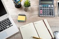 office desk background with laptop, empty notepad, pen calculator and supplies Royalty Free Stock Photo