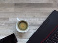 Office desk with black laptop, golden colour mobile phone, a cup of coffee. Business. Success. Coffee break. Office work. Top view Royalty Free Stock Photo