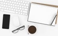 Office desk with blank empty book, keyboard, glasses, phone and coffee cup top view on white background, workspace design Royalty Free Stock Photo