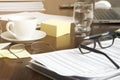 office desk with business documents, glasses, laptop and coffee, financial concept