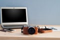 Office Desk with Camera and Office equipment Notebook, Cell Phone and passport. Royalty Free Stock Photo
