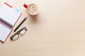 Office desk with coffee cup, notepad and glasses Royalty Free Stock Photo