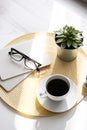 Office desk with coffee cup, succulent plant, eyeglasses and notepad. Minimal style image of business table Royalty Free Stock Photo