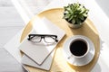 Office desk with coffee cup, succulent plant, eyeglasses and notepad. Minimal style image of business table Royalty Free Stock Photo