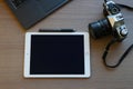 Office desk without coffee with film camera, pad, touch pen, computer, top view Royalty Free Stock Photo