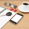 office desk : coffee and phone with car key,eyeglasses,notepad,heart Royalty Free Stock Photo