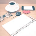 office desk : coffee and phone with car key,eyeglasses,notepad,heart vintage style Royalty Free Stock Photo