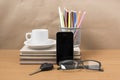 Office desk : coffee and phone with car key,eyeglasses,stack of Royalty Free Stock Photo