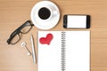 office desk : coffee and phone with key,eyeglasses,notepad,heart