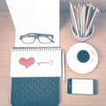 office desk : coffee with phone,wallet,calendar,heart,notepad,eyeglasses,color pencil box,key vintage style Royalty Free Stock Photo