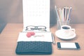 office desk : coffee with phone,wallet,calendar,heart,notepad,eyeglasses,color pencil box,key vintage style Royalty Free Stock Photo