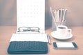 office desk : coffee with phone,wallet,calendar,heart,notepad,eyeglasses,color pencil box vintage style Royalty Free Stock Photo