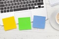 Office desk with colorful stickers, coffee and laptop Royalty Free Stock Photo