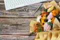 Office desk with computer keyboard, pen and mixed flower bouquet on top of wood background Royalty Free Stock Photo