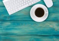 Office desk with copy space. Digital devices wireless keyboard and mouse on red wooden table with cup of coffee, top view Royalty Free Stock Photo