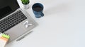 Office desk copy space with laptop, coffee, notepad and pencil with plant house decorative. Royalty Free Stock Photo