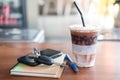 Office desk with cup of iced coffee and phone, car key on notebook Royalty Free Stock Photo