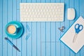 Office desk flat lay with keyboard, coffee cup and notebook. View from above. Royalty Free Stock Photo