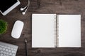 The office desk flat lay view with keyboard, mouse, tree, book, pencil and earphone on wood texture background