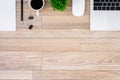 The office desk flat lay view with laptop, mouse, tree, black clip, coffee cup, notebook, pencil on wood texture background Royalty Free Stock Photo