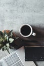 The office desk flat lay view with laptop, mouse, tree, paper clip, coffee cup, notebook, pencil Royalty Free Stock Photo