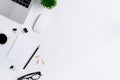 The office desk flat lay view with laptop, mouse, tree, pink and yellow paper clip, coffee cup, notebook, pencil, black glasses on Royalty Free Stock Photo