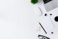 The office desk flat lay view with laptop, mouse, tree, pink and yellow paper clip, coffee cup, notebook, pencil, black glasses on Royalty Free Stock Photo