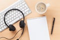 Office desk with headset and keyboard Royalty Free Stock Photo