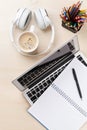 Office desk with laptop, coffee and headphones Royalty Free Stock Photo