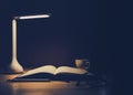 Office desk with Led lamp,cup of coffee and paperwork stack