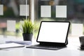 Office desk with mock up tablet with blank sccreen and supplies on white table. Royalty Free Stock Photo