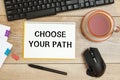 Notebook with text CHOOSE YOUR PATH near office supplies