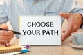 Notebook with text CHOOSE YOUR PATH near office supplies