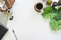 Office desk notepad paper, laptop with coffee cup plant and cactus with top view desk