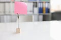 Office desk with pink sticker and paper clip Royalty Free Stock Photo