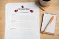 Office desk with resume information, Black coffee, note paper and pencil. Royalty Free Stock Photo