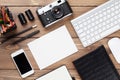 Office desk with supplies, camera and blank card Royalty Free Stock Photo