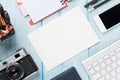 Office desk with supplies, camera and blank card Royalty Free Stock Photo
