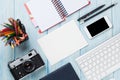 Office desk with supplies, camera and blank card Royalty Free Stock Photo