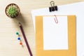 Office Desk Table with a Blank, Paper, Pencil, Plant Pot, Clips and Supplies. Workplace. Top View on a Wooden Background with Copy Royalty Free Stock Photo