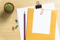 Office Desk Table with a Blank, Paper, Pencil, Plant Pot, Clips and Supplies. Workplace. Top View on a Wooden Background with Copy Royalty Free Stock Photo