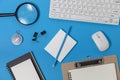 Office desk table of Business workplace and business objects of keyboard,mouse,white paper,notebook,pencil,compass on blue Royalty Free Stock Photo